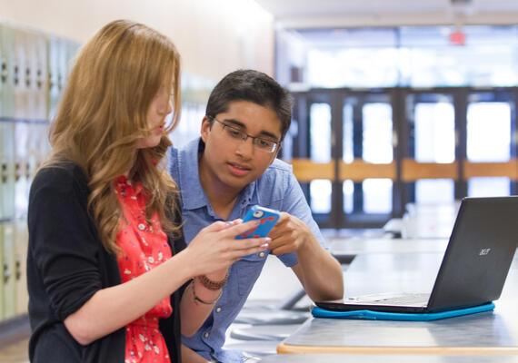 Two students looking at a phone
